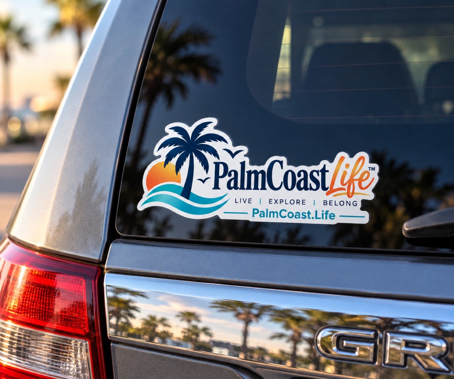 PalmCoast.Life window sticker with the palm, sun, and wave mark — Live, Explore, Belong